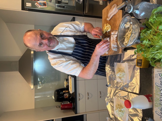 Professional chef posing with prepared weekly batch cooking meals